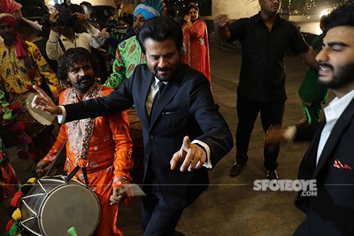 Anil Kapoor dances with the band while Arjun Kapoor looks on