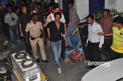 shah rukh khan waves to the media while on the sets of the ring