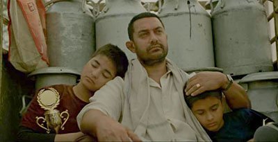 aamir khan with his onscreen daughters in a still from dangal