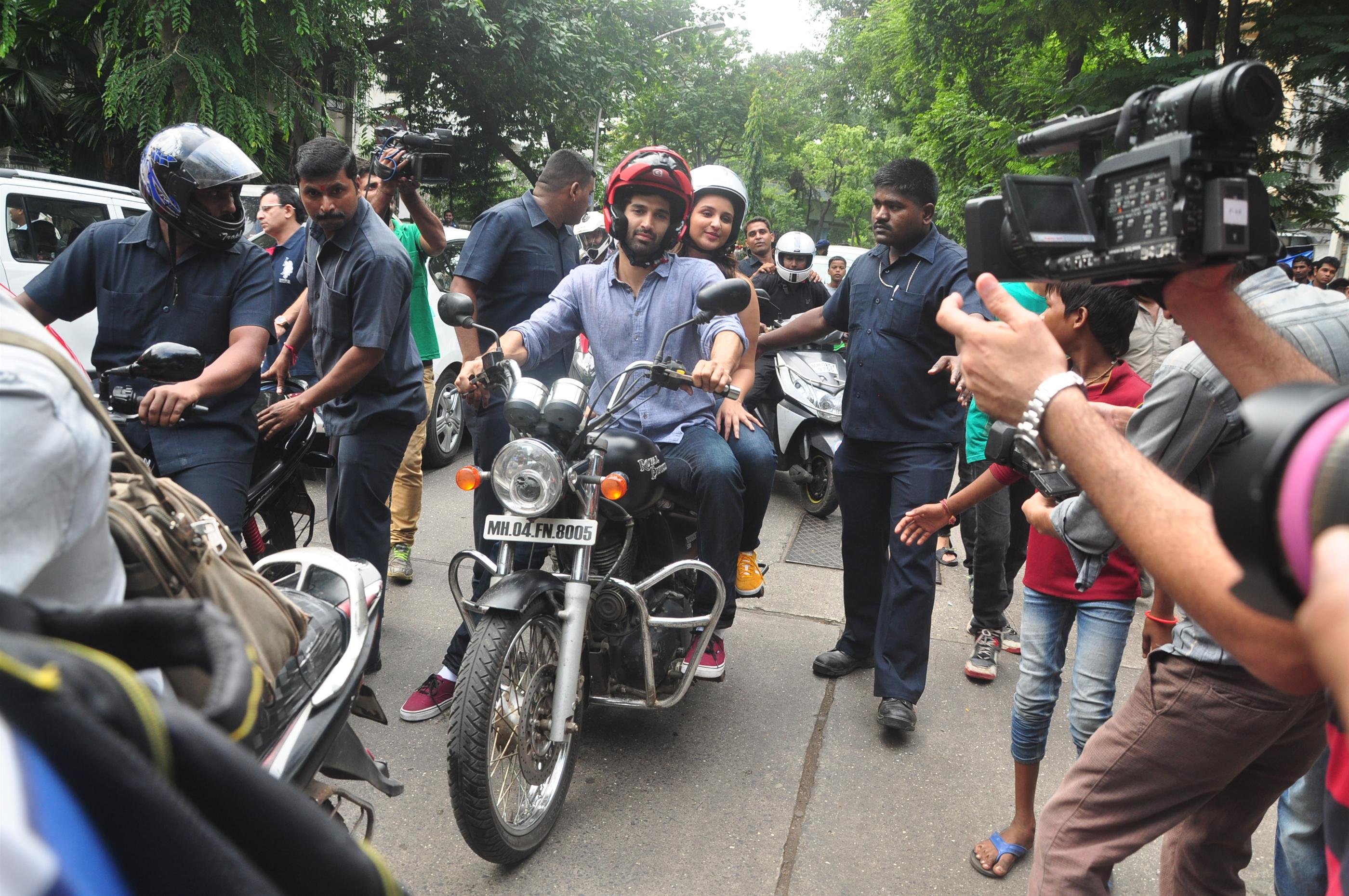 aditya and parineeti riding a bike