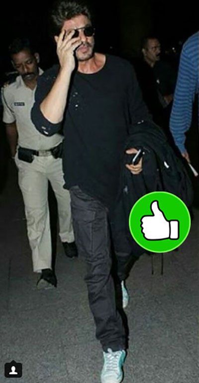 shahrukh khan looks stunning at the mumbai airport sporting a black t-shirt and jeans