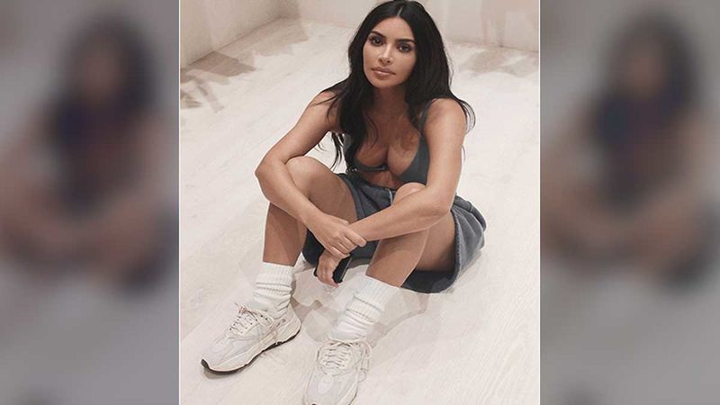 Kim Kardashian strikes a pose in her cavernous closet