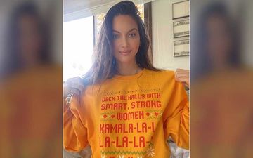 Ahead Of Christmas 2020, Olivia Munn Shares A Blissful Photo Dressed In A Kamala Harris Inspired Holiday Sweater That Reads 'Kamala-La-La-La-La-La-La'