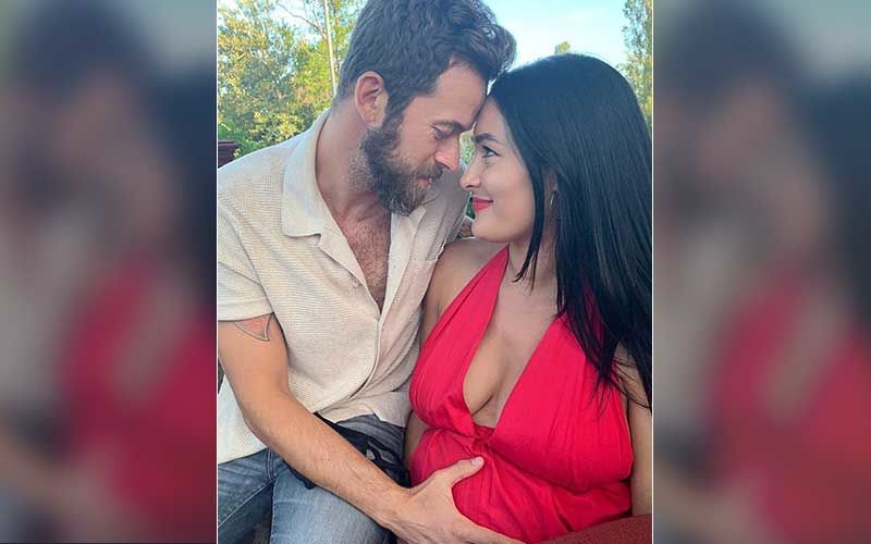 Nikki Bella Welcomes Her First Child With Fiancé Artem Chigvintsev; Couple Share A Family Pic Holding Hands With The Little One