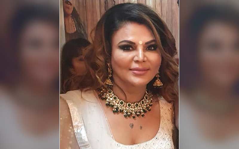 Bigg Boss 14’s Rakhi Sawant Is Spotted Walking, Wearing A PPE Suit In Andheri; ‘Meri Maa Ko Dekhne Jaane Ke Liye Aise Kapde Mein Jaana Padta Hai’