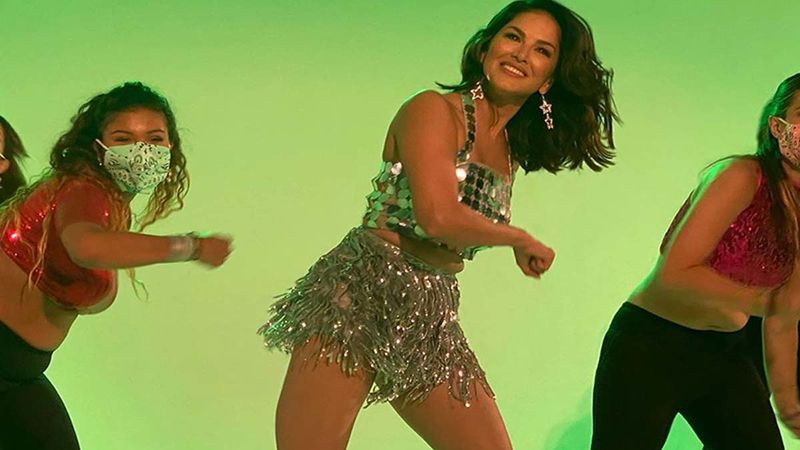 Sunny Leone Resumes Work, Dons A Sexy Shimmery Mini Dress As Background Artists Dance Away In Masks