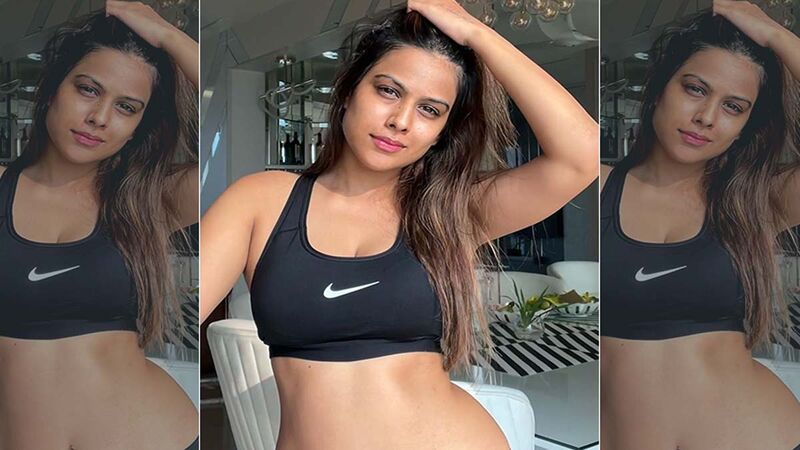 Nia Sharma Flaunts Her Wash Board Abs In A Black Athleisure, Gives A Twist To The Phrase ‘Make Hay While The Sun Shines’ In Her Caption