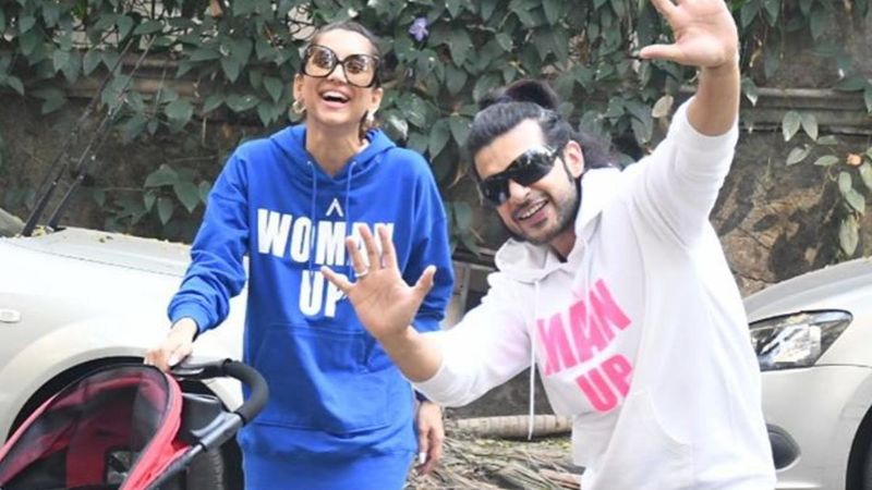 Anusha Dandekar And Karan Kundra Take Their Little One For A Morning Stroll; Sport Matching Slogan Tees