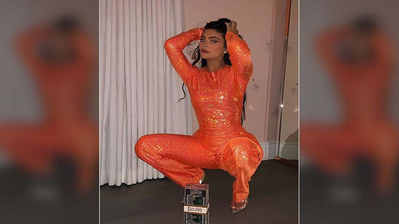 Kylie Jenner Welcomes October With A Shimmery Orange Jumpsuit And A Dollar Clutch