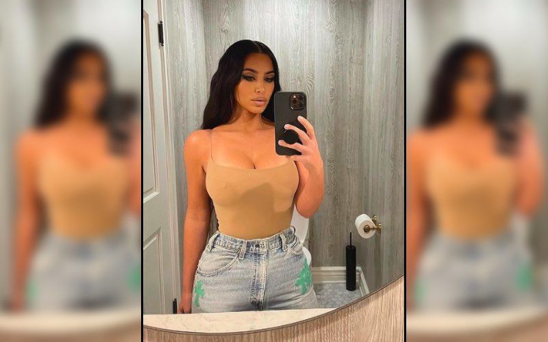 Kim Kardashian flaunts her perfectly toned midriff in a crop top