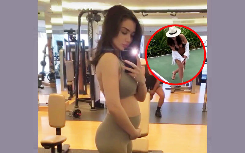 Amy Jackson Flaunts Her Baby Bump In Bikini While Playing Golf - Watch Video