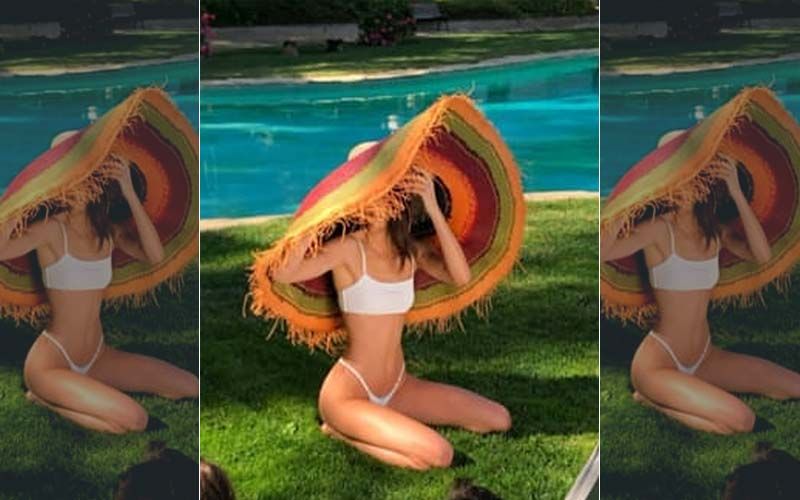 Kendall Jenner Strikes A Pose By The Pool In A Bikini And A Huge Sun Hat That Is Bigger Than Herself