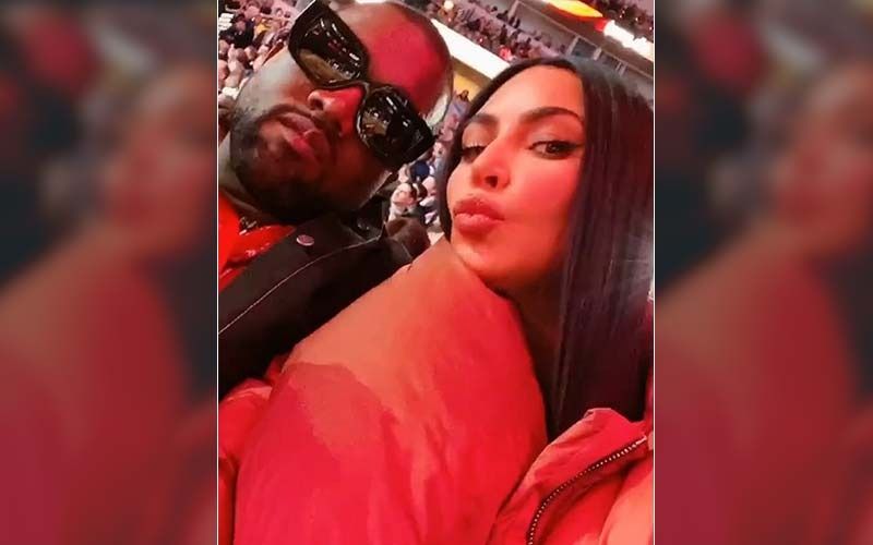 Kim Kardashian Plants A Smooch On Kanye West; Wears A Padded Coat That Swallows Her Whole At The NBA Game