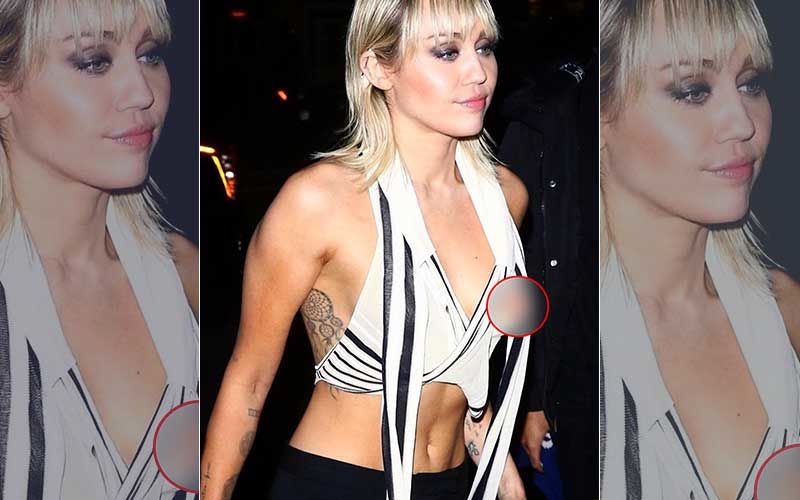Wearing a black-and-white striped crop top, Miley Cyrus 'suffered&apos...
