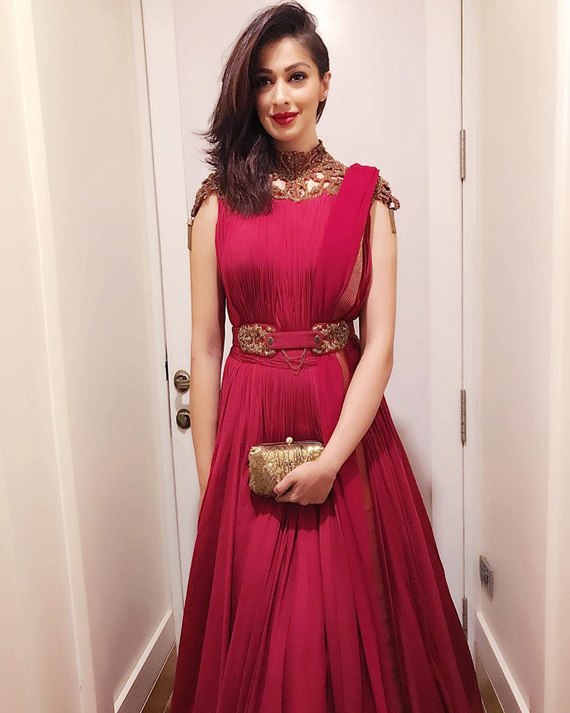 raai laxmi in a red gown