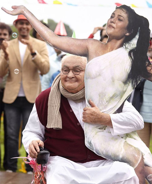 rishi poosing with a cutout of mandakini in a still from kapoor and sons