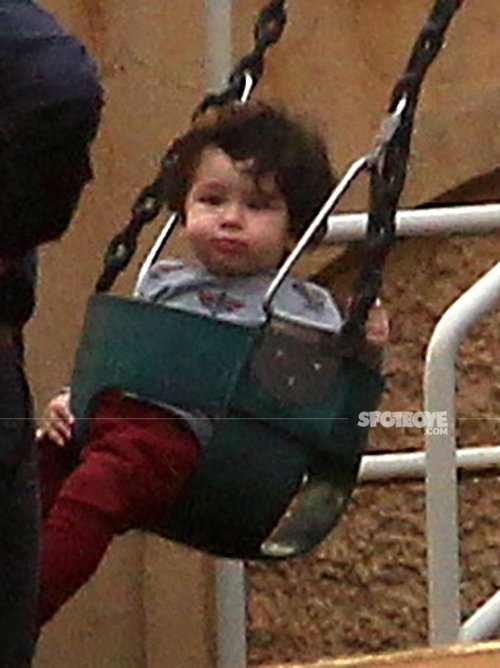 taimur ali khan looks straight to the cameras as they click his pictures on the swing